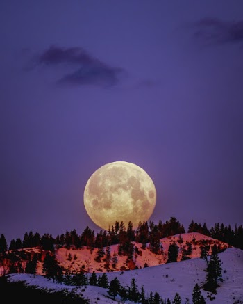 Moon Over Snowcapped Mountain