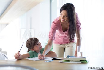 Mother and daughter coloring at dining table