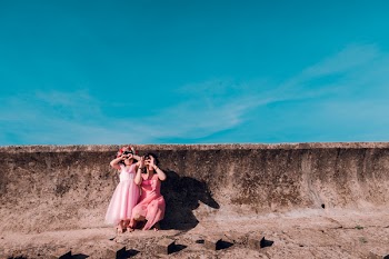 Mother and Daughter Posing Near a Wall