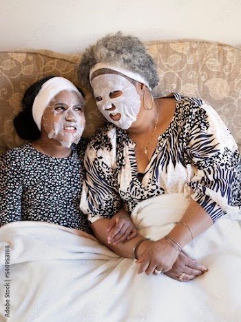 Mother and daughter relaxing with face masks