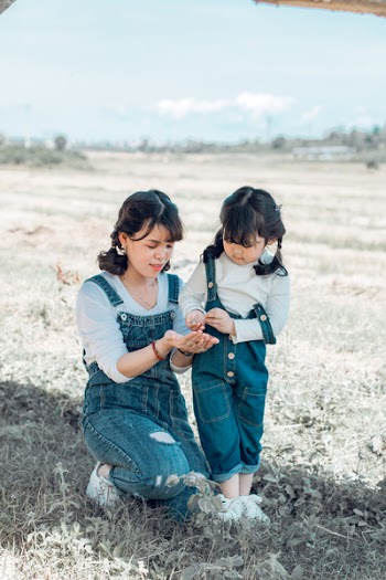 Mother and Daughter Wearing Bib-and-brace Overalls