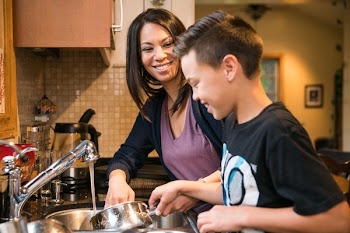 Mother And Son Washing Dishes