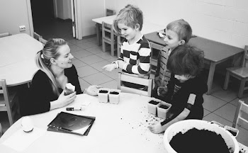 Mother and Three Child Near Table With Mud