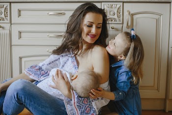 Mother in the kitchen with baby and daughter Free Photo