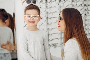 Mother with little son in the glasses store Free Photo