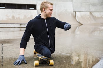 Motivated handicapped  guy with a longboard in the skatepark