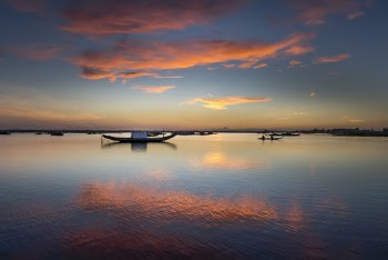 Motor Boats on Sea Under Orange and Blue Skeis