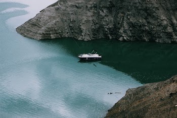 Motorboat In The Middle Of Two Mountains