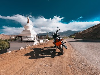 Motorcycle Parked on Dirt Beside Road