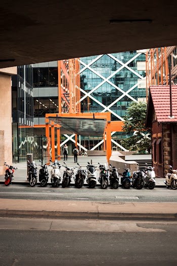 Motorcycles Parked Beside Building