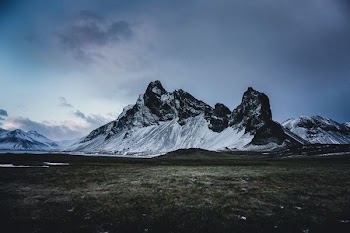 mountain alp under cloudy sky