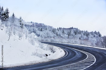 Mountain asphalt road after snowfall.