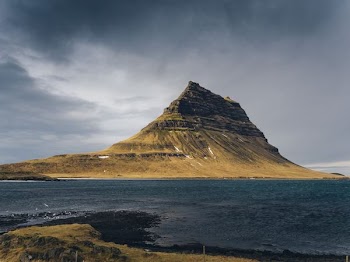 mountain beside body of water