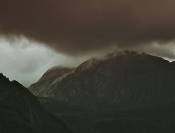 mountain covered by cumulus cloud