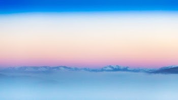 mountain covered with snow and fogs