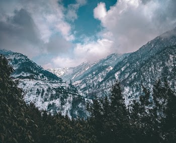 Mountain Filled With Snow Under Cloudy Sky