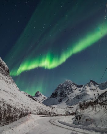 Mountain Landscape with Aurora Borealis Shining in Evening Sky