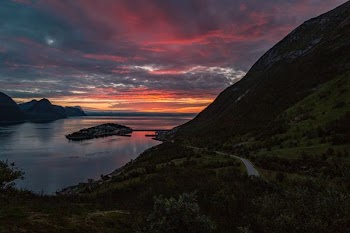 mountain near body of water during sunset