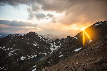 mountain near road and body of water