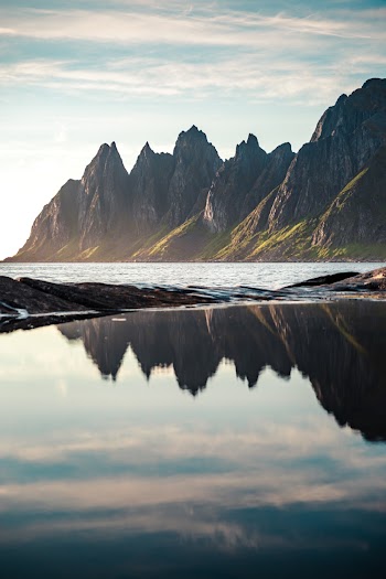 Mountain Range Near Body of Water