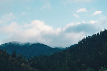 Mountain Range Under White Clouds