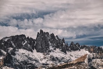 mountain range under white clouds