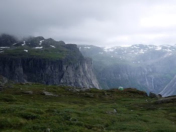 mountain range with grass and snow