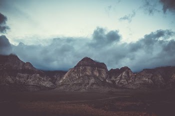 mountain ranges under cumulus clouds