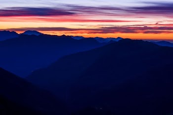 mountain ranges under orange sky during sunset