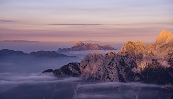 Mountain Ranges Under Orange Sunset
