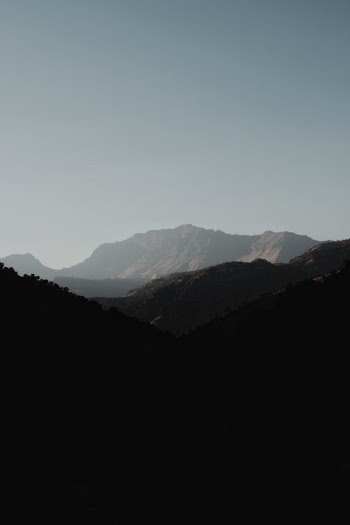 Mountain ridge under cloudless sky in daytime · Free Stock Photo