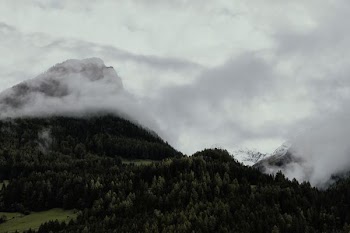 mountain surrounded by white clouds