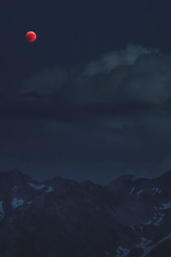 mountain under cloudy full moon