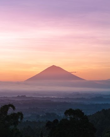 mountain under orange sky