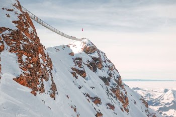 mountain with bridge covered with snow