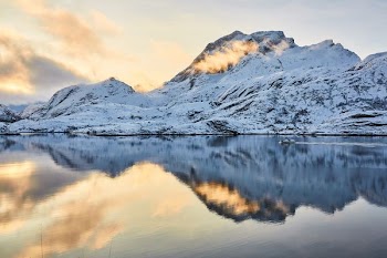 mountain with snow and reflection on water