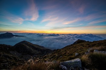 Mountains Above White Clouds Under Blue Sky