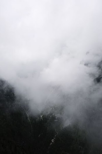 mountains and smoke during daytime