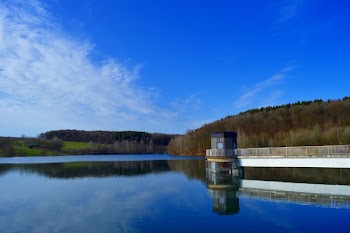 Mountains Near Body of Water Under Blue Sky