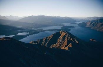 mountains surrounded body of water