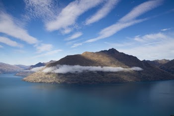 Mountains Surrounded by Water during Daylight