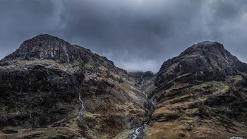 mountains under cloudy sky during daytime