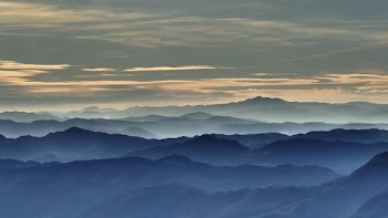 mountains under gray clouds during daytime