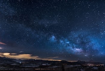 mountains with trees under white star at night