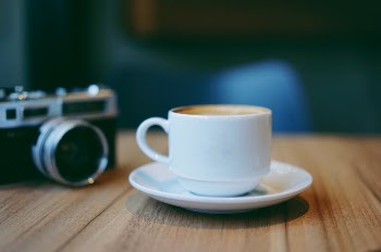 Mug Beside the Land Camera on Table