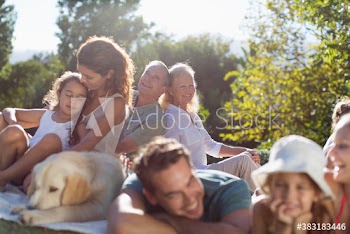Multi-generation family, relaxing in sunny backyard