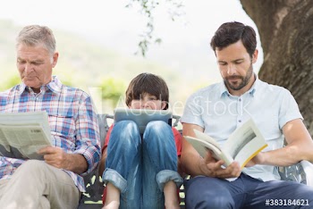 Multi-generation family with newspaper digital tablet and book