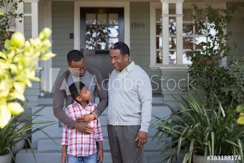 Multi-generation men talking in front of house