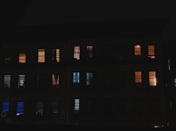 Multi-storey Building With Open Windows during Nighttime