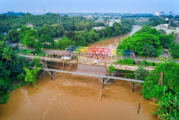 Multicolored Bridge Near Green Trees